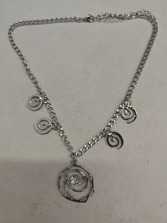 Gold spiral donut alloy jewellery set showing necklace, bracelet, and ear hooks on a plain background.