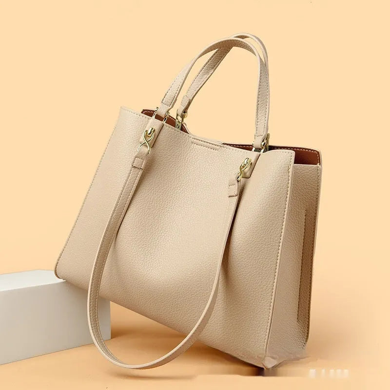 Women's horizontal square messenger tote bag in PU leather with crossbody strap and internal compartments.