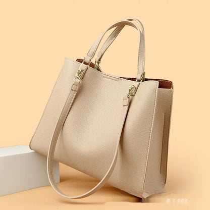 Women's horizontal square messenger tote bag in PU leather with crossbody strap and internal compartments.