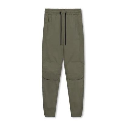 Men's grey fitness trousers with ankle ties, made from quick-drying polyester, for exercise and casual use.