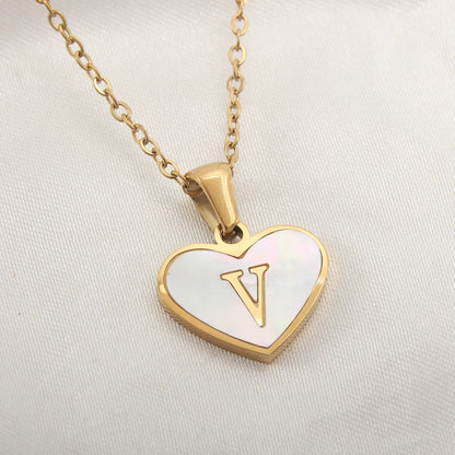 Gold-plated clavicle necklace with a white shell heart pendant, personalised with a letter from A to Z.