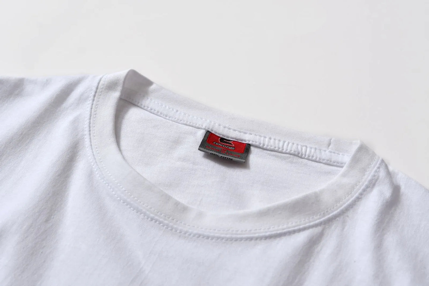White cotton pullover overalls with a pattern, short sleeves, and a round neck on a teenager.