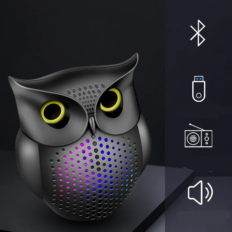 Black cartoon owl design wireless Bluetooth speaker on a surface.