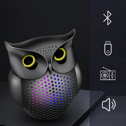 Black cartoon owl design wireless Bluetooth speaker on a surface.