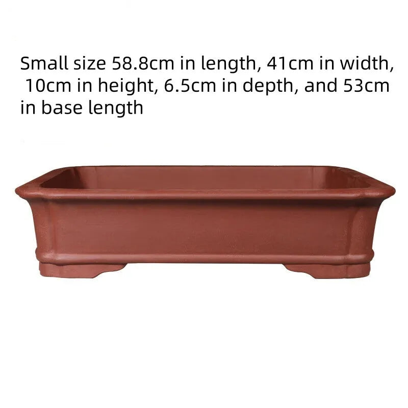 Handmade rectangular purple clay bonsai pot showing natural clay texture and rectangular shape with drainage