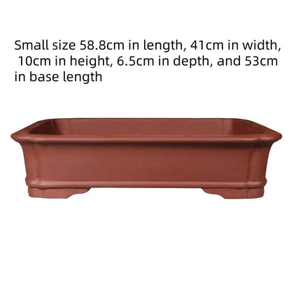 Handmade rectangular purple clay bonsai pot showing natural clay texture and rectangular shape with drainage