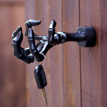Black skeleton hand wall hook with articulated fingers for hanging keys and jewellery