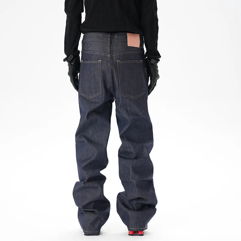 Man wearing dark blue loose-fit straight-leg denim jeans, showcasing the casual relaxed silhouette.