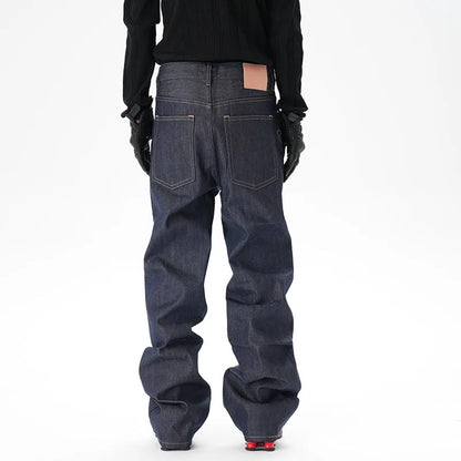 Man wearing dark blue loose-fit straight-leg denim jeans, showcasing the casual relaxed silhouette.