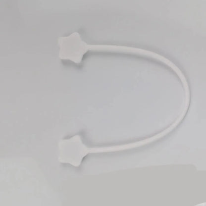 Compact purple silicone cable winder with magnet, shown coiling a white headphone cable.