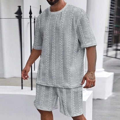 Knitted short-sleeve pullover and matching shorts set in light grey, laid flat.