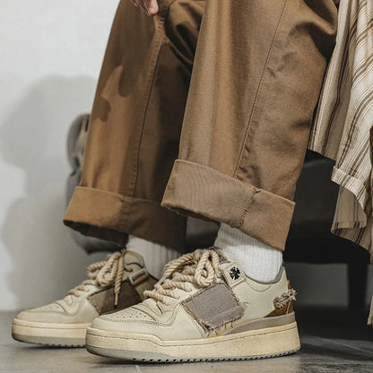 Beige low-top vintage-style skate shoes on a white background, showing round toe and lace-up front.
