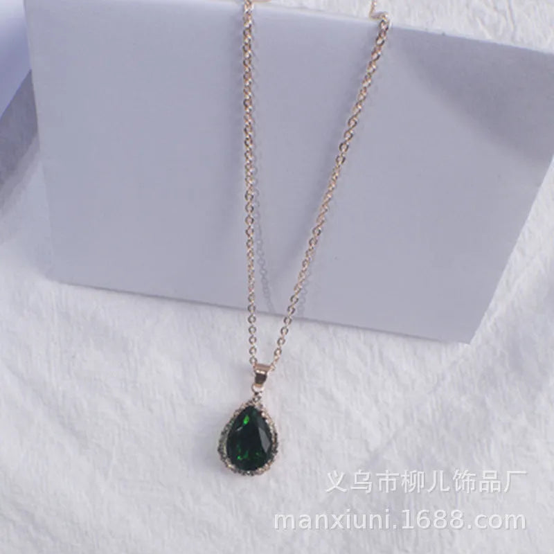 Rose gold geometric water drop pendant necklace on a model, showing adjustable chain and sparkling stone inlay.
