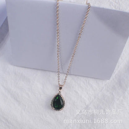 Rose gold geometric water drop pendant necklace on a model, showing adjustable chain and sparkling stone inlay.