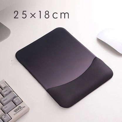 Square cloth mouse pad with grey silicone gel wrist rest and hand pillow on a wooden desk.
