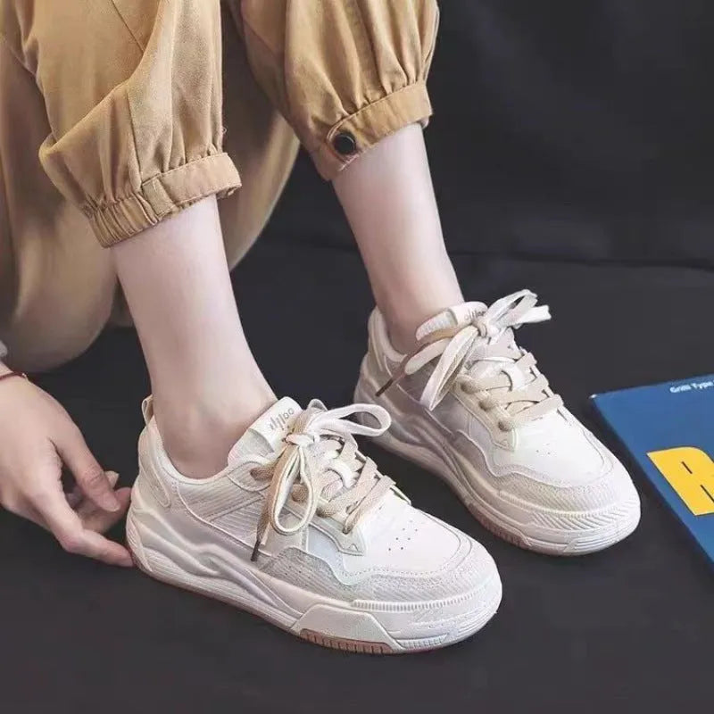 Women's beige and pink low-top sneakers with a rubber sole featuring hidden height increase.