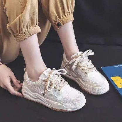 Women's beige and pink low-top sneakers with a rubber sole featuring hidden height increase.