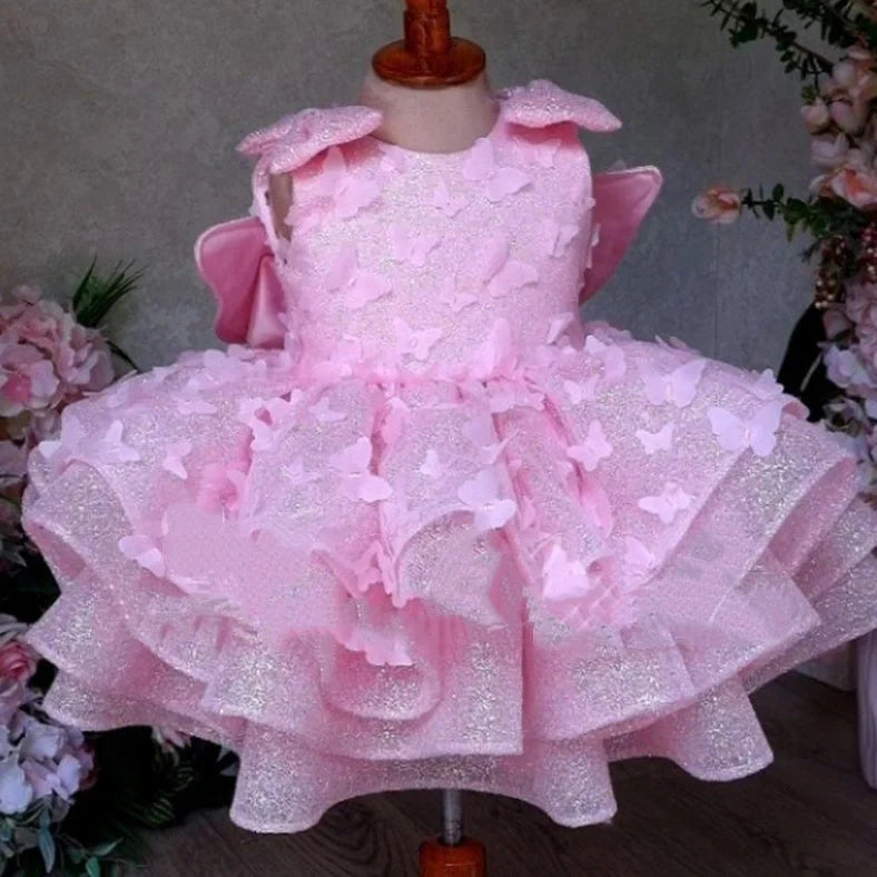 Pink sleeveless girls' dress with three-dimensional butterfly decoration on front