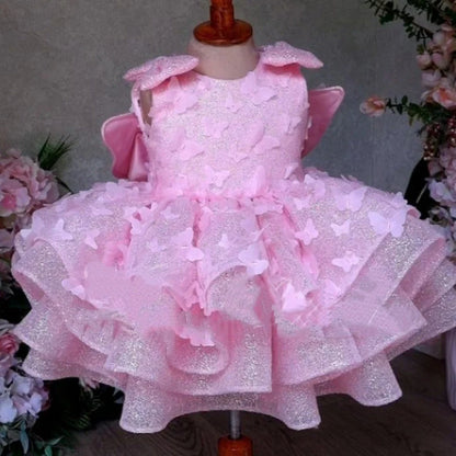 Pink sleeveless girls' dress with three-dimensional butterfly decoration on front
