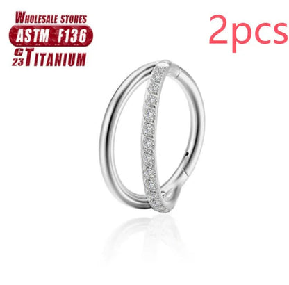 Pair of titanium alloy nose rings on a plain background showing silver, gold, black, and rose gold colour options.