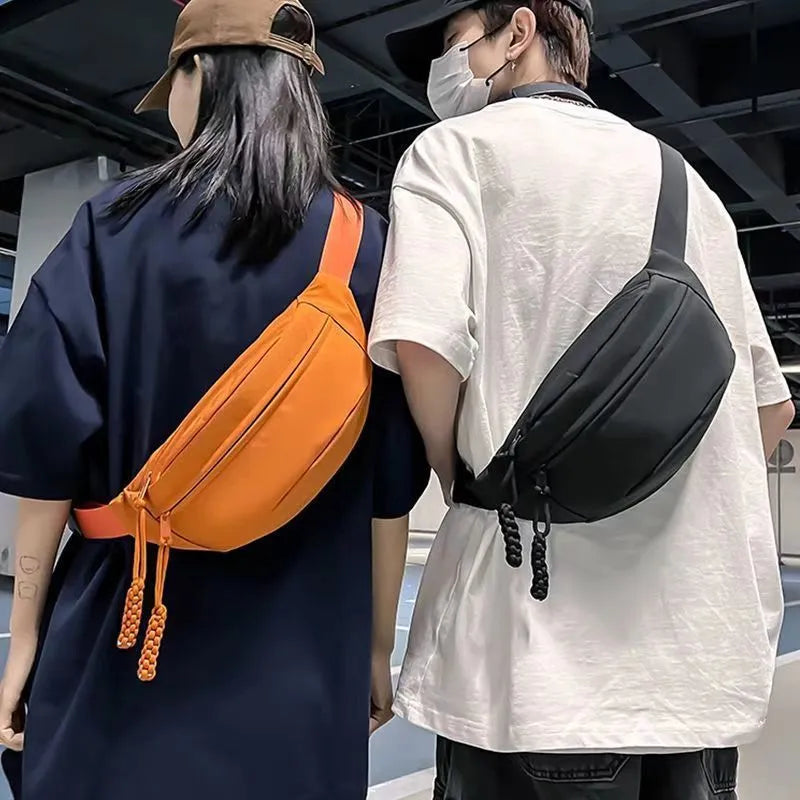 Men's polyester crossbody bag in black colour showing shoulder strap and front compartment