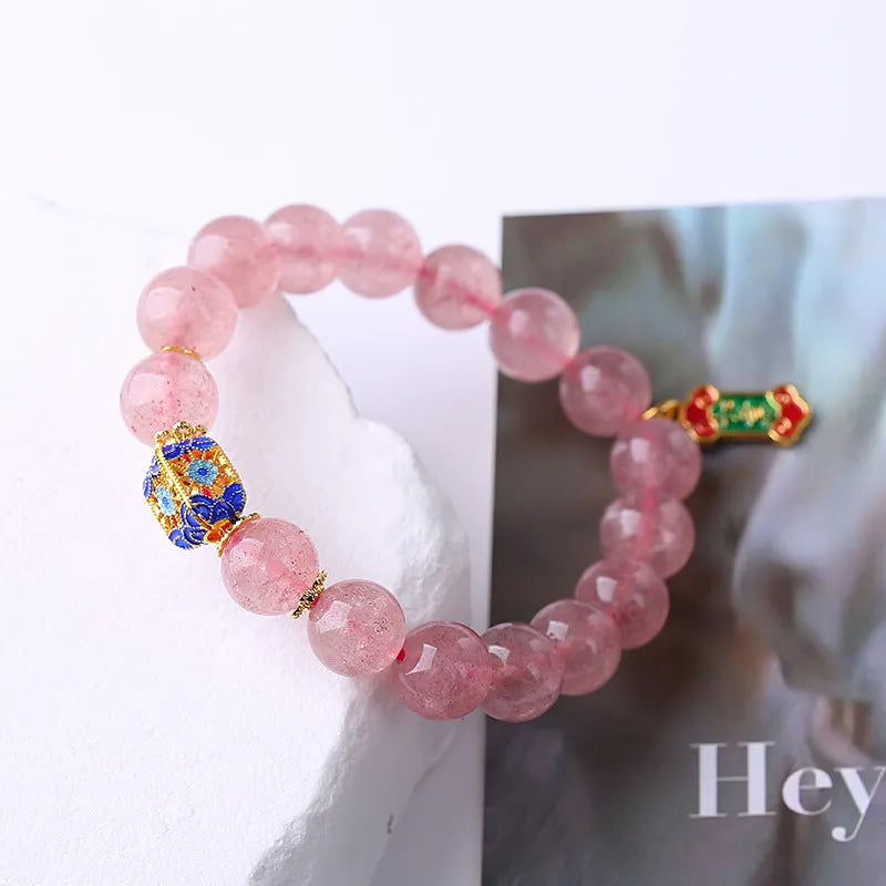 Pink strawberry quartz crystal bracelet with Ruyi charm, hand-woven in a national style.