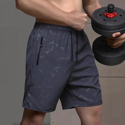 Men's loose-fit casual sports shorts in grey with a printed pattern, showing elastic waistband and fifth-pants length.