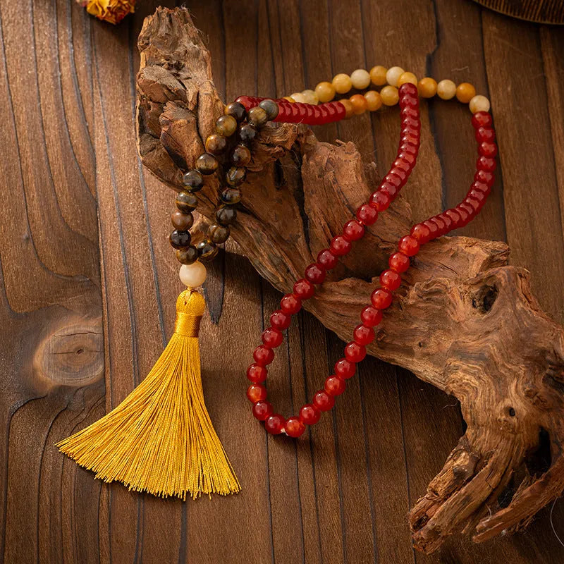 Vintage bohemian-style long beaded sweater chain with a tassel, showing necklace and bracelet lengths.