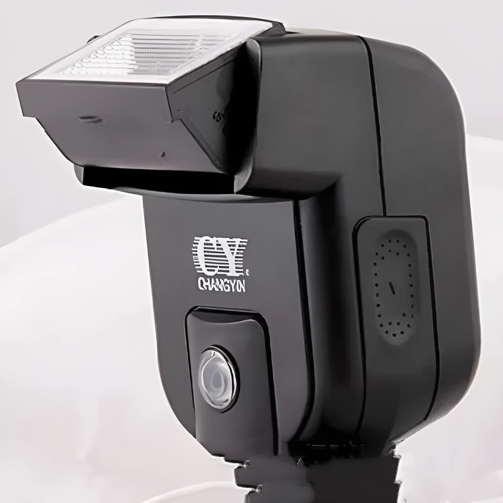 Compact black SLR camera flash unit with head tilted upwards, showing hot shoe mount.
