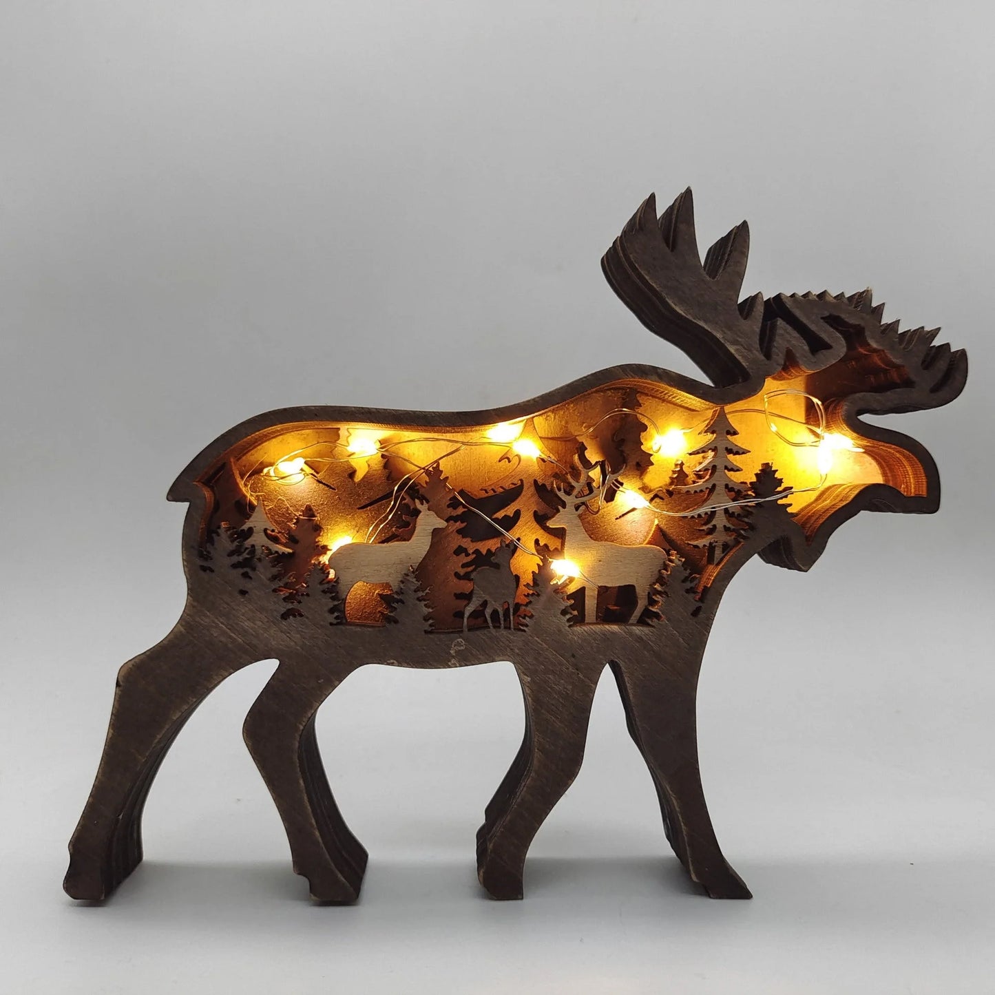 Handcrafted wooden elk and brown bear Christmas decorations with forest theme