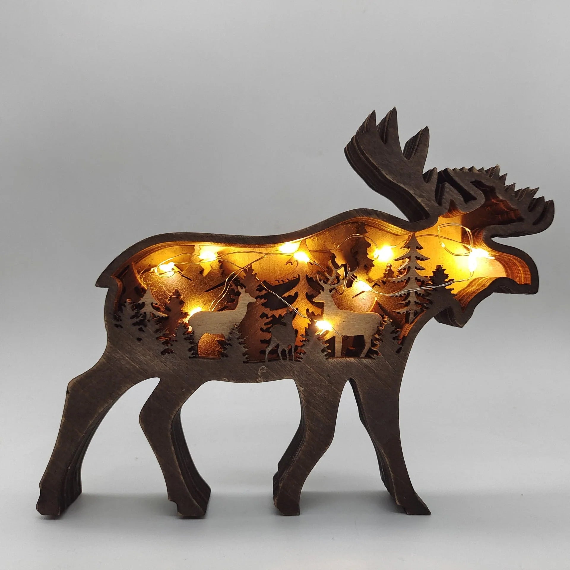 Handcrafted wooden elk and brown bear Christmas decorations with forest theme