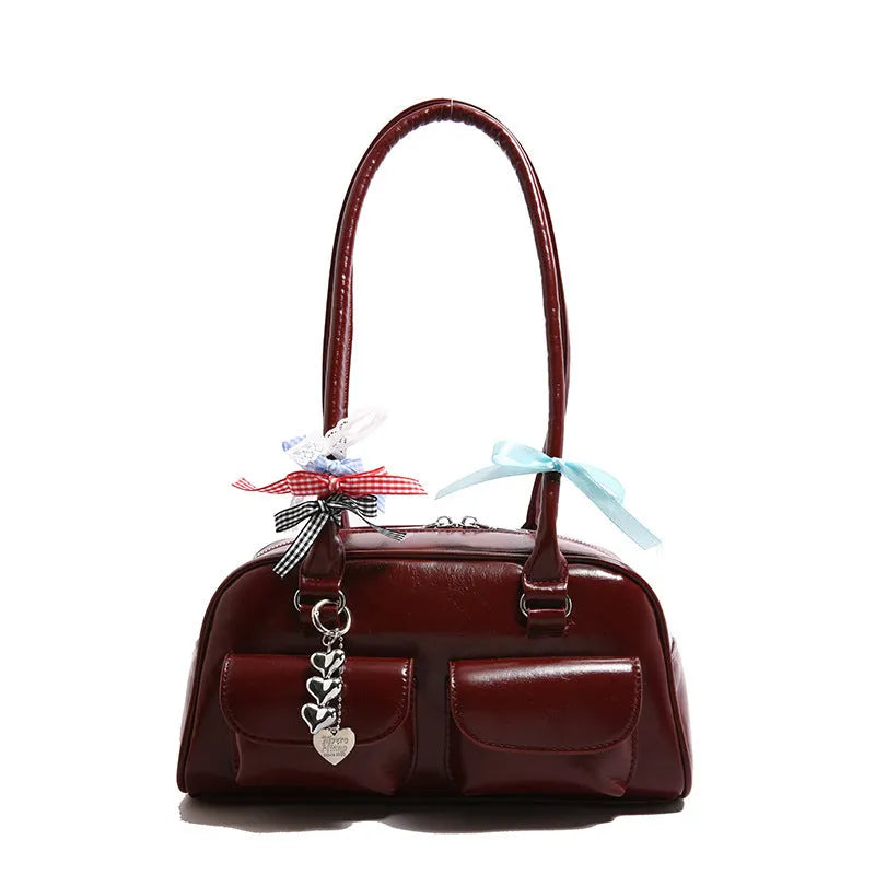 Retro brown PU leather women's pillow bag with a double shoulder strap and flap closure.