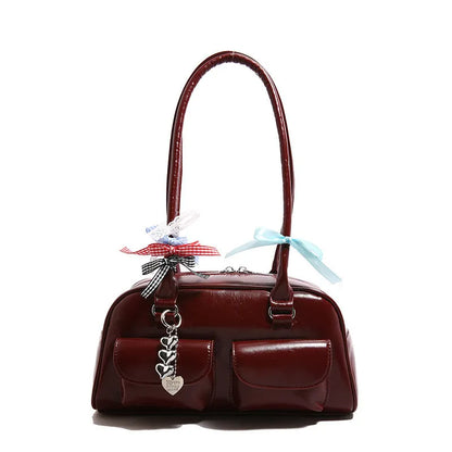 Retro brown PU leather women's pillow bag with a double shoulder strap and flap closure.