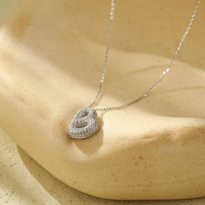 Stainless steel initial pendant necklace with zircon accents, personalized with your choice of letter.