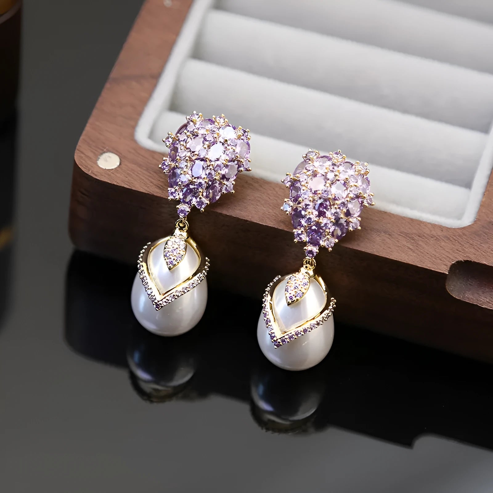Women's drop-shaped freshwater pearl earrings with zircon inlay on 18K gold-plated settings.