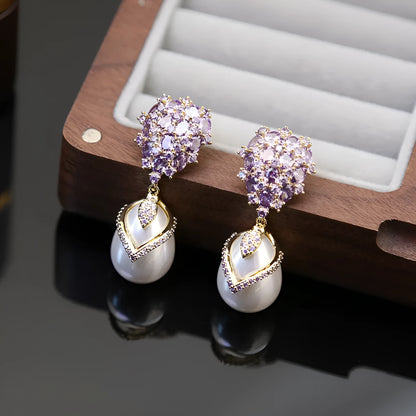 Women's drop-shaped freshwater pearl earrings with zircon inlay on 18K gold-plated settings.
