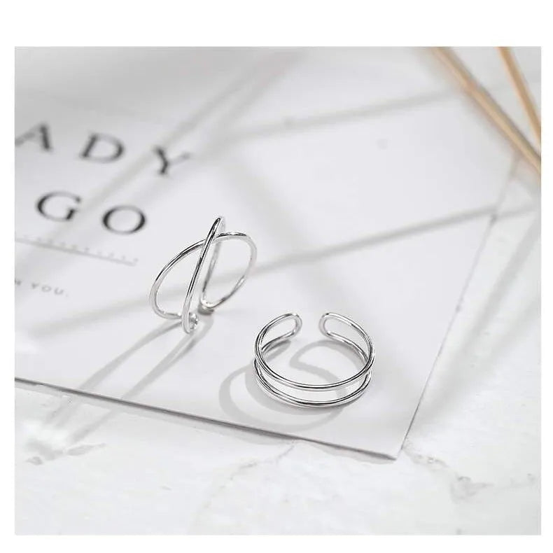 Adjustable silver plated geometric cross ring for women in gold tone or silver tone on a copper base.