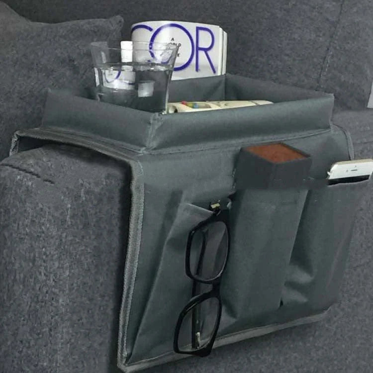 Sofa arm organizer bag in black with multiple pockets for remote controls and magazines