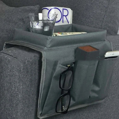 Sofa arm organizer bag in black with multiple pockets for remote controls and magazines