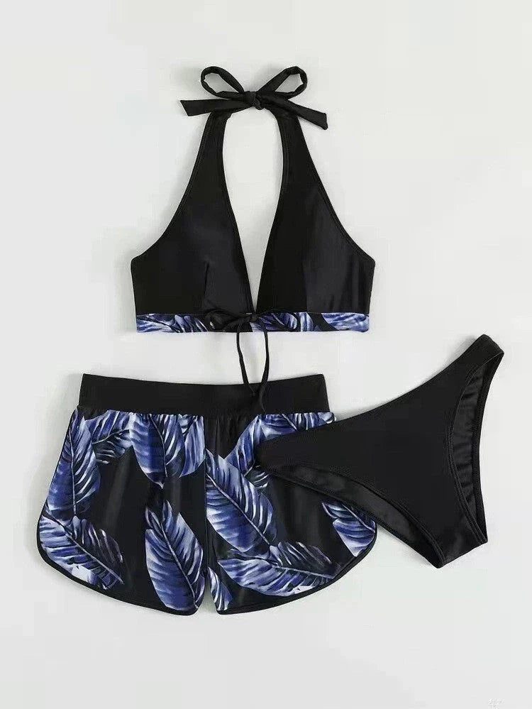 A stylish 3-piece swimsuit set featuring a unique leaf print design, including a top, bottoms, and matching shorts.