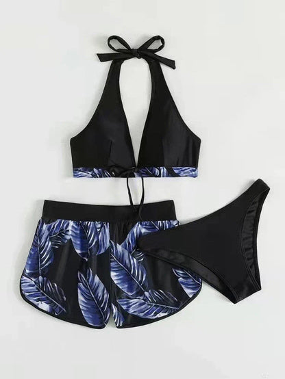 A stylish 3-piece swimsuit set featuring a unique leaf print design, including a top, bottoms, and matching shorts.