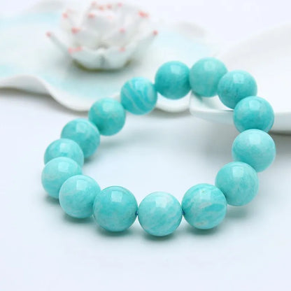 Natural teal blue amazonite gemstone bead bracelet on a white background, showing stretch elastic cord.