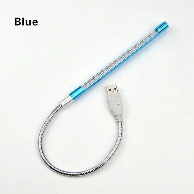 Spiral-shaped silver aluminium alloy USB LED desk lamp on a wooden table.