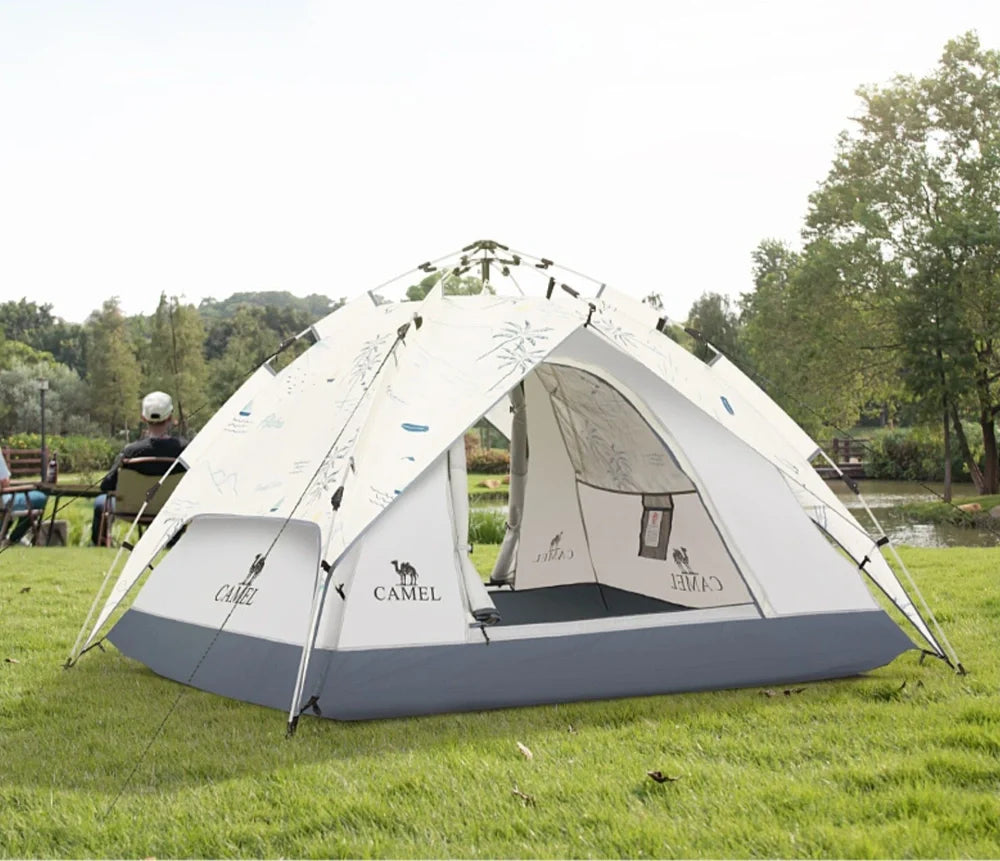 Automatic folding camping tent in blue set up on grass showing 220cm length and 120cm height