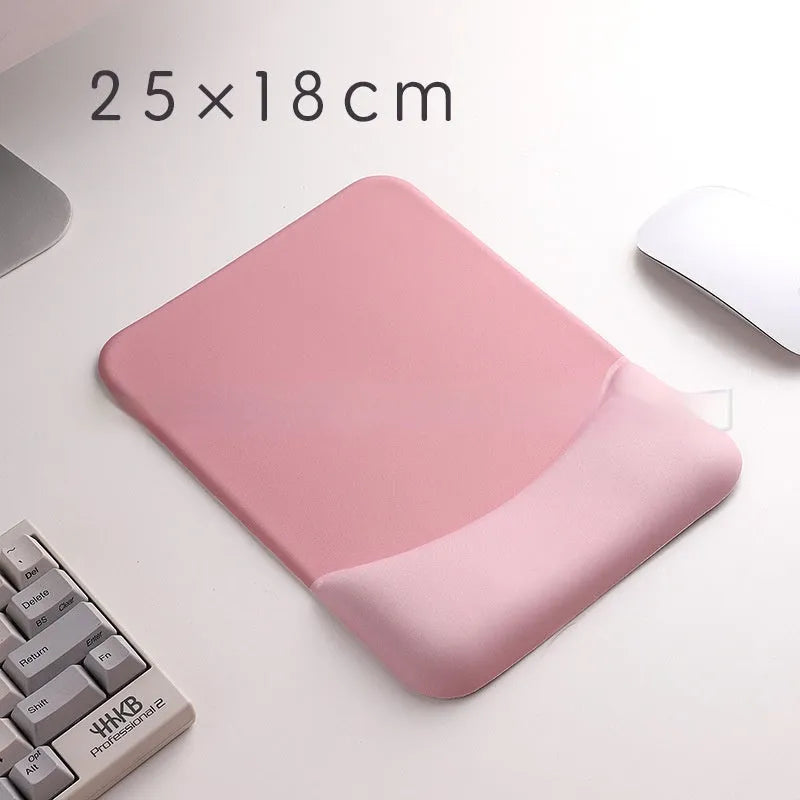 Square cloth mouse pad with grey silicone gel wrist rest and hand pillow on a wooden desk.