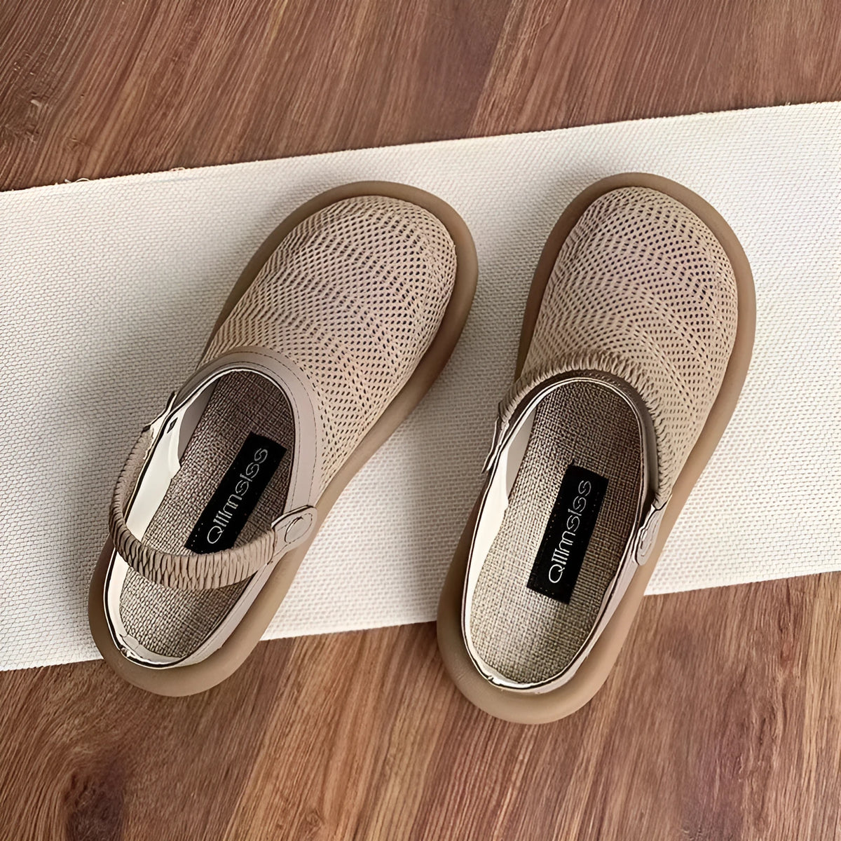 Women's beige linen slip-on shoes with mesh lining and a soft rubber sole.