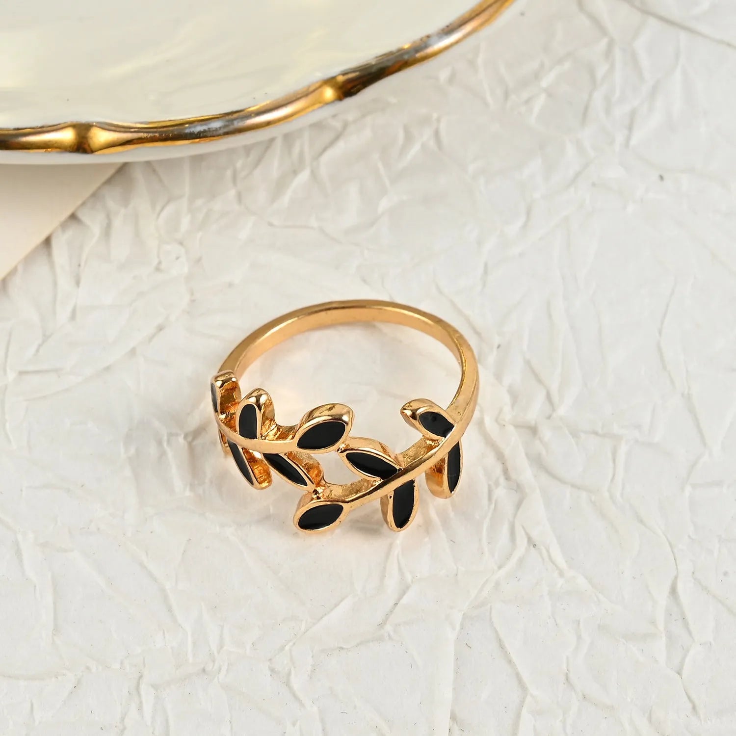 Gold electroplated geometric ring with leaf motif and acrylic accents for women's index finger