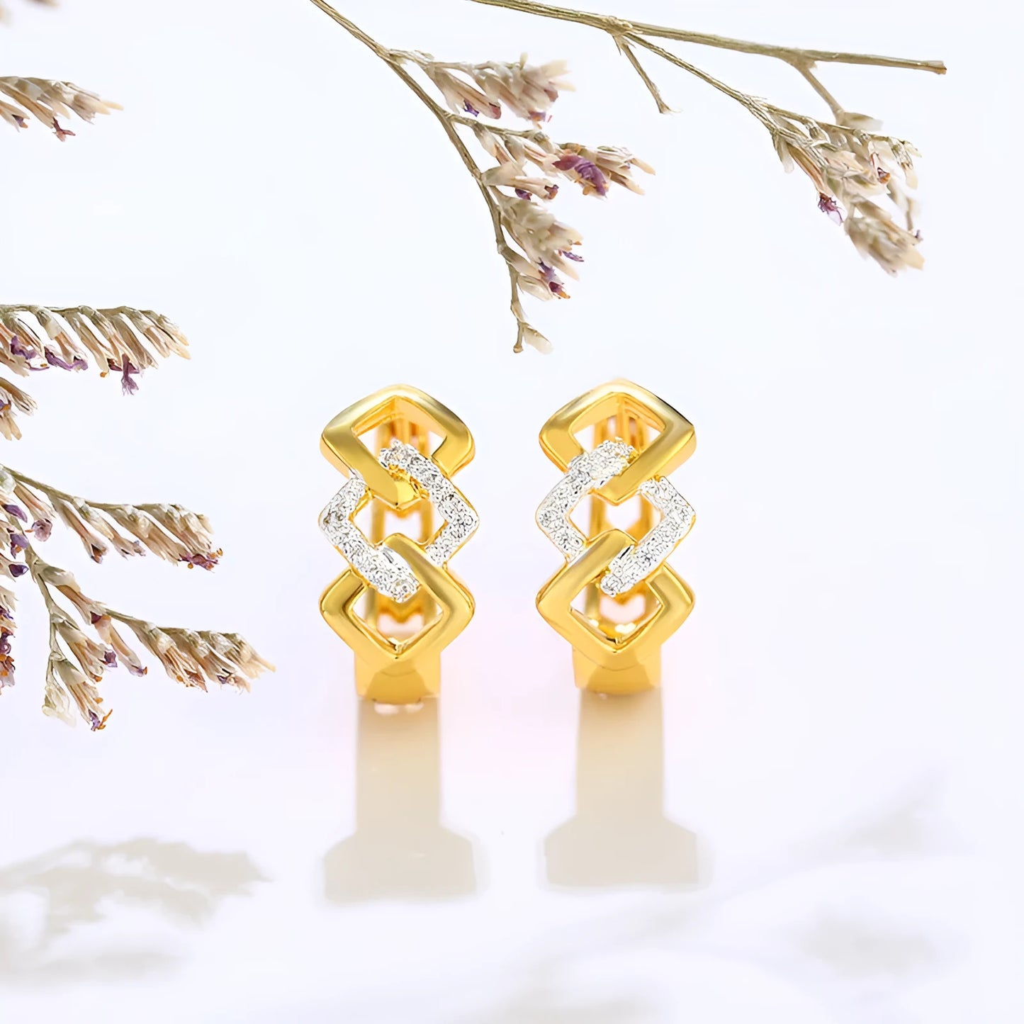 Gold geometric hollow-out alloy stud earrings on a plain background.