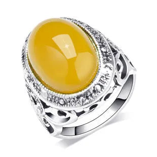 Geometric antique silver amber alloy ring with fluorescent beeswax plating on a model's finger.