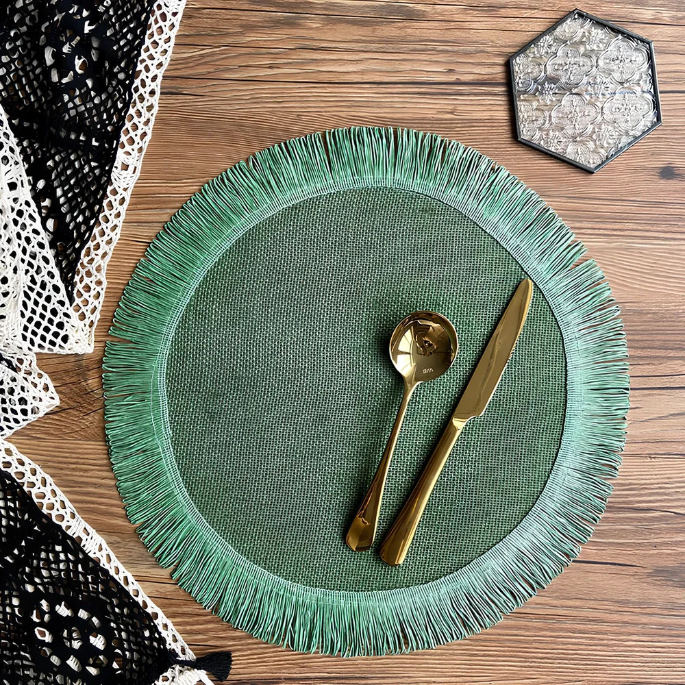 Round handwoven jute placemat with decorative tassels measuring 30cm diameter in Christmas green colour